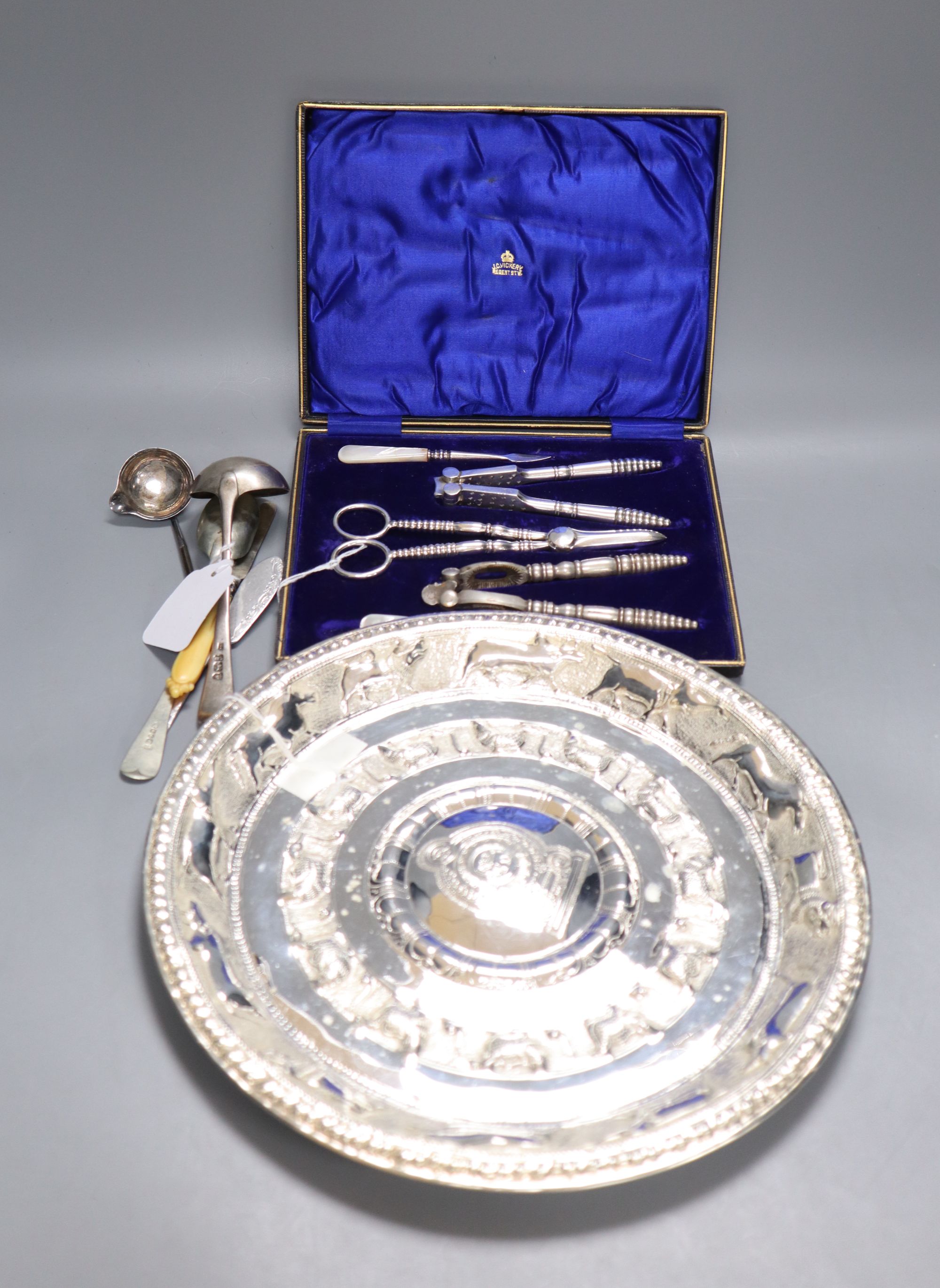 An Eastern embossed plated tray, a cased plated nut and grape set, a plated coffee pot, a silver sauce ladle and sundries